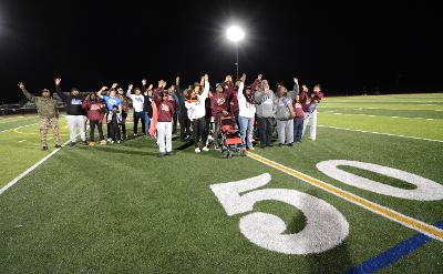 Family, former coaches, and players gathered on the Milford High School field to honor Troy